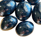 Opposite side of Black Tourmaline palm stone, showing glassy finish, hand-selected from Alaotra-Mangoro, Madagascar.