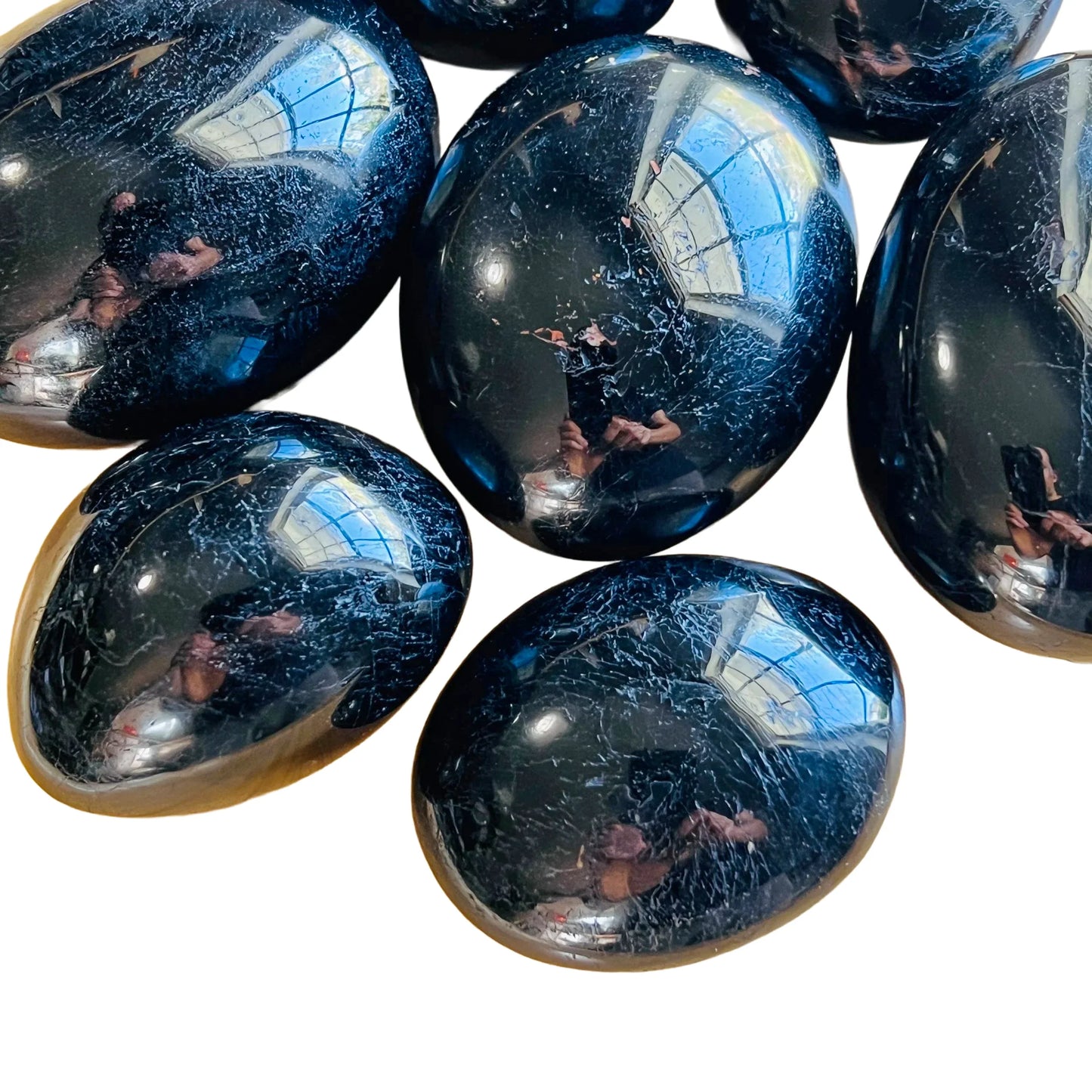 Opposite side of Black Tourmaline palm stone, showing glassy finish, hand-selected from Alaotra-Mangoro, Madagascar.