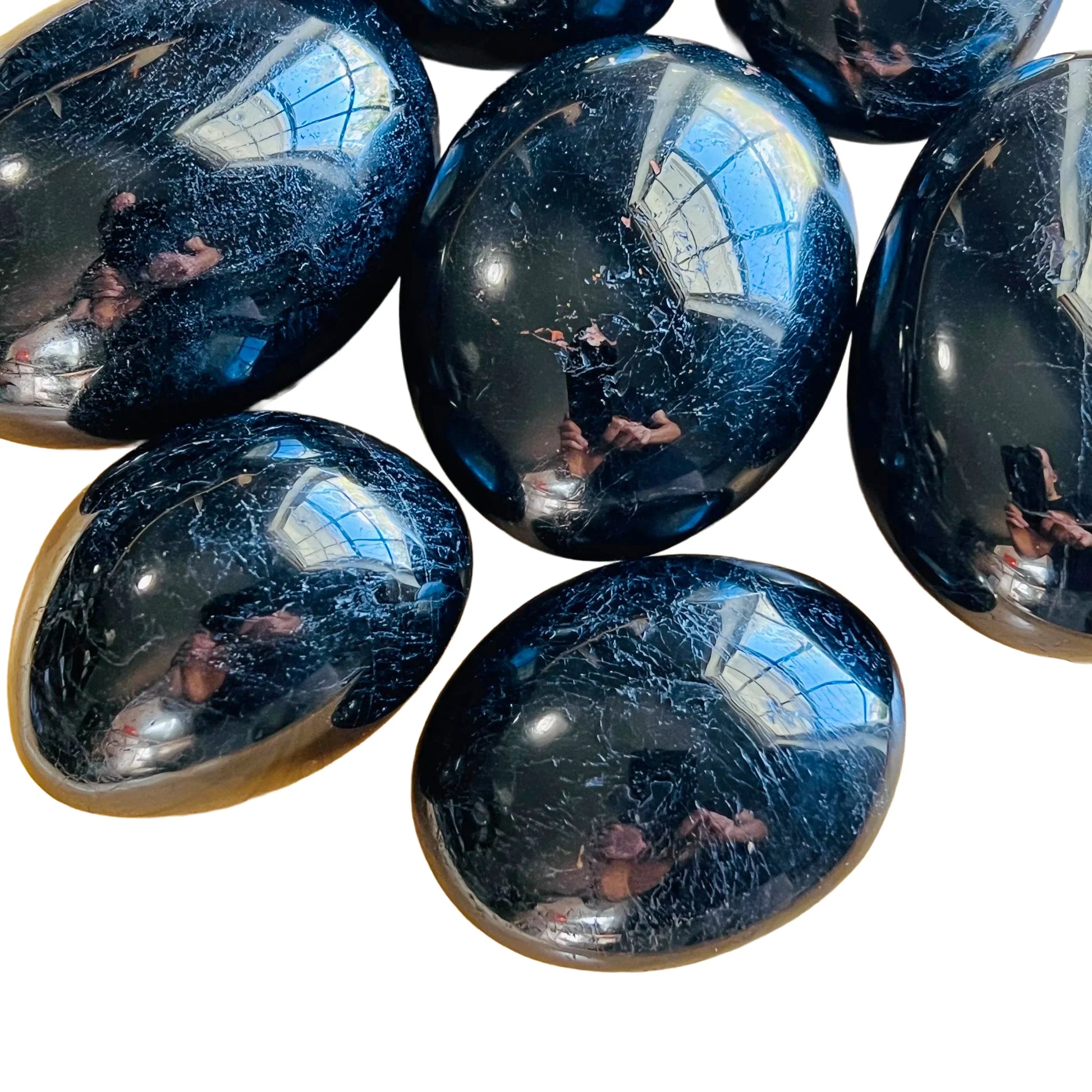Opposite side of Black Tourmaline palm stone, showing glassy finish, hand-selected from Alaotra-Mangoro, Madagascar.