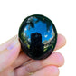 Held in hand, a Black Tourmaline palm stone kept near for Protection and Grounding.
