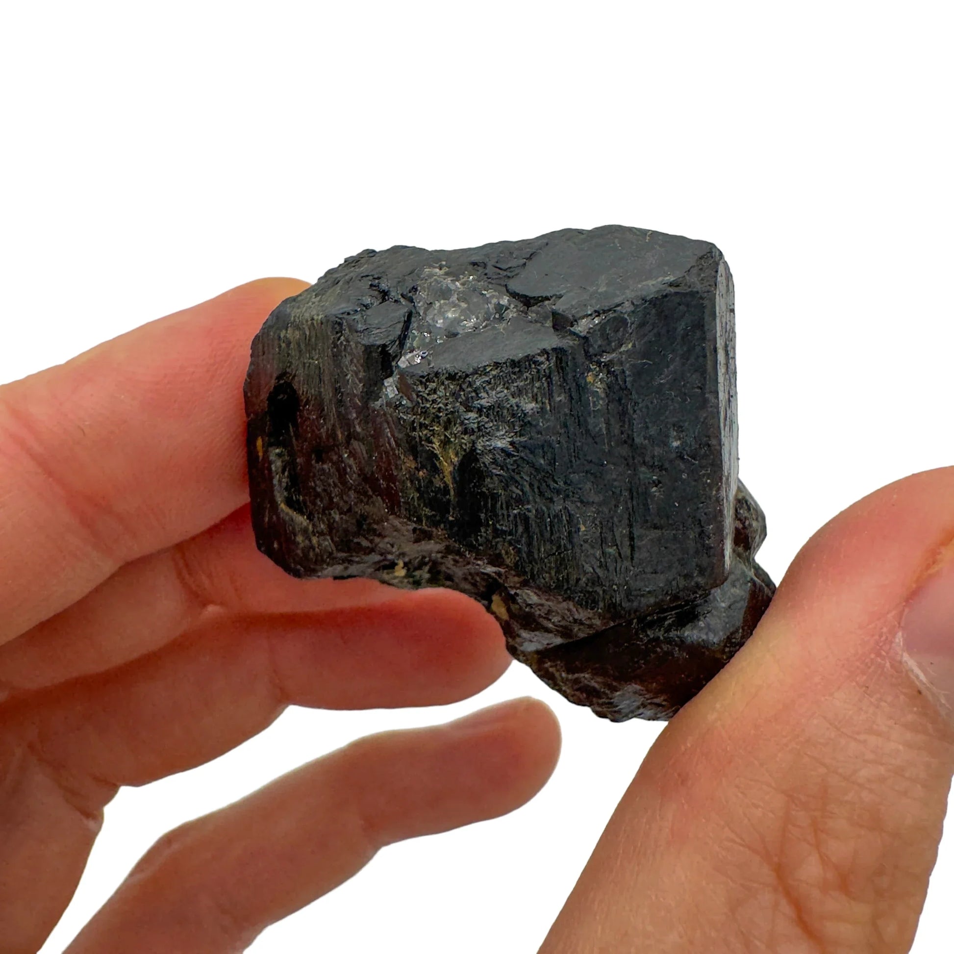 Grade aa black tourmaline raw held in hand for size reference