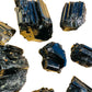 Grade aaa black tourmaline raw held in hand for size reference