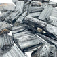 In-hand view of a Black Tourmaline raw stone, from Minas Gerais, Brazil.