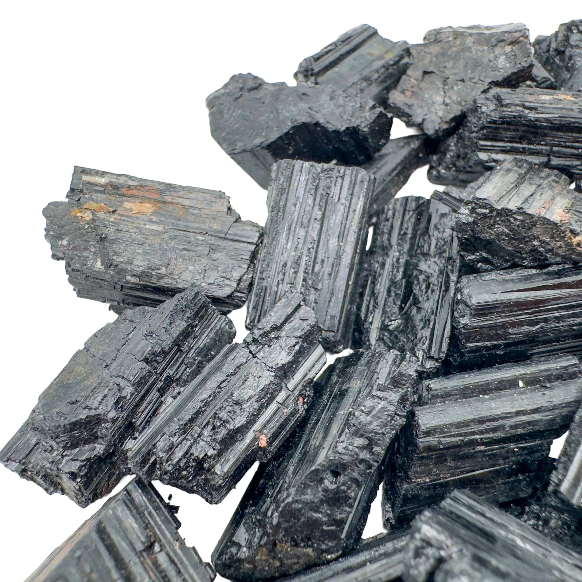 Grade aa black tourmaline raw held in hand for size reference