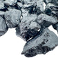 Side profile of Grade A Black Tourmaline raw stone, showing open form.
