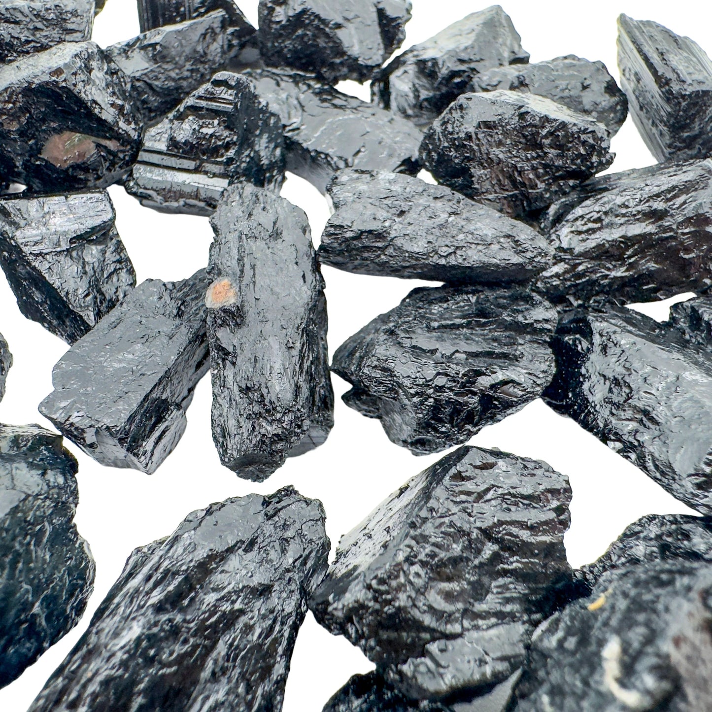 Hand-scale shot of a Black Tourmaline raw stone, sourced from Brazil.