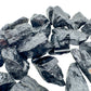 Resting display of Black Tourmaline raw crystal, from Minas Gerais, Brazil, captured in natural daylight.