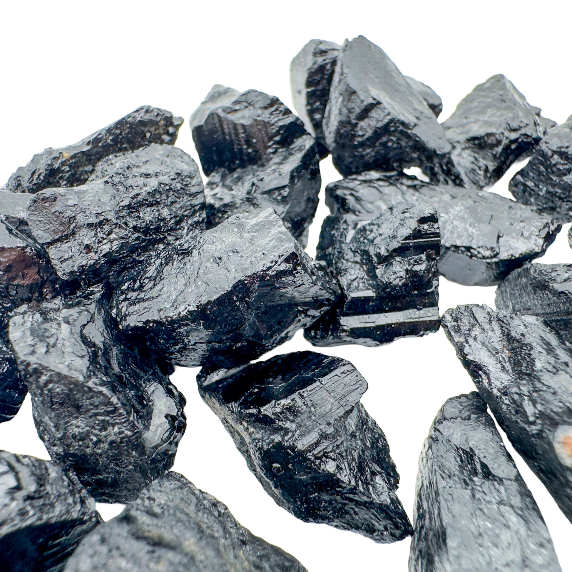 Resting display of Black Tourmaline raw crystal, from Minas Gerais, Brazil, captured in natural daylight.