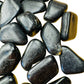 Top-side view of Black Tourmaline tumbled stone, turned to for Protection and Grounding, showing color depth.