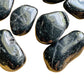 Detail shot of Grade AA Black Tourmaline tumbled stone under natural light