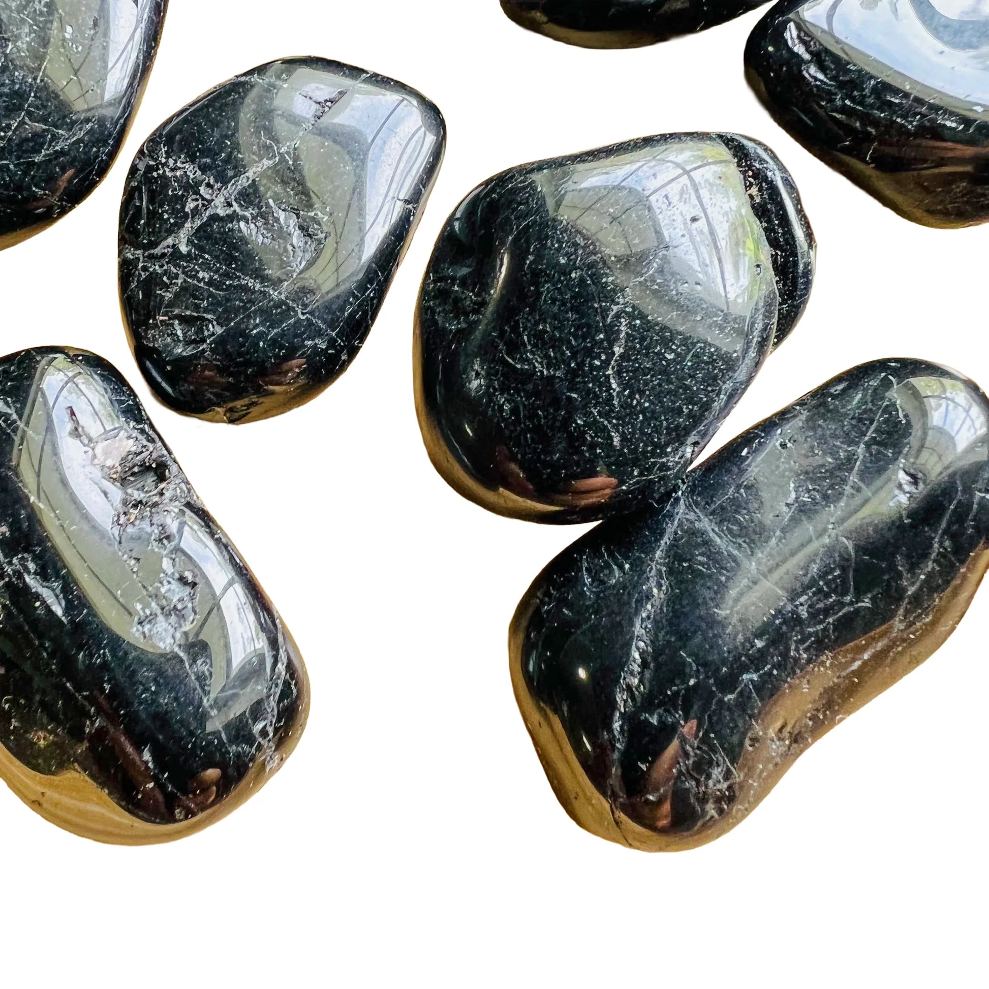Detail shot of Grade AA Black Tourmaline tumbled stone under natural light