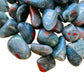 Natural surface of Bloodstone tumbled stone, sourced from Hhohho, Eswatini.