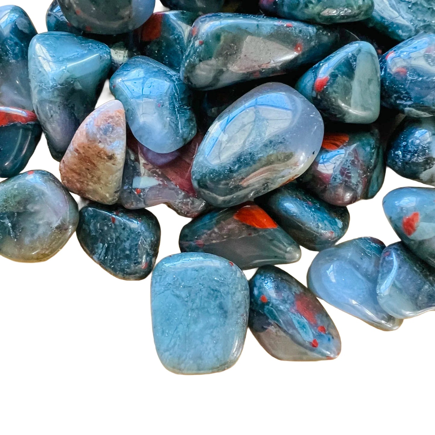 Overhead view of Grade AA Bloodstone tumbled stone, from Eswatini, showing natural variation.