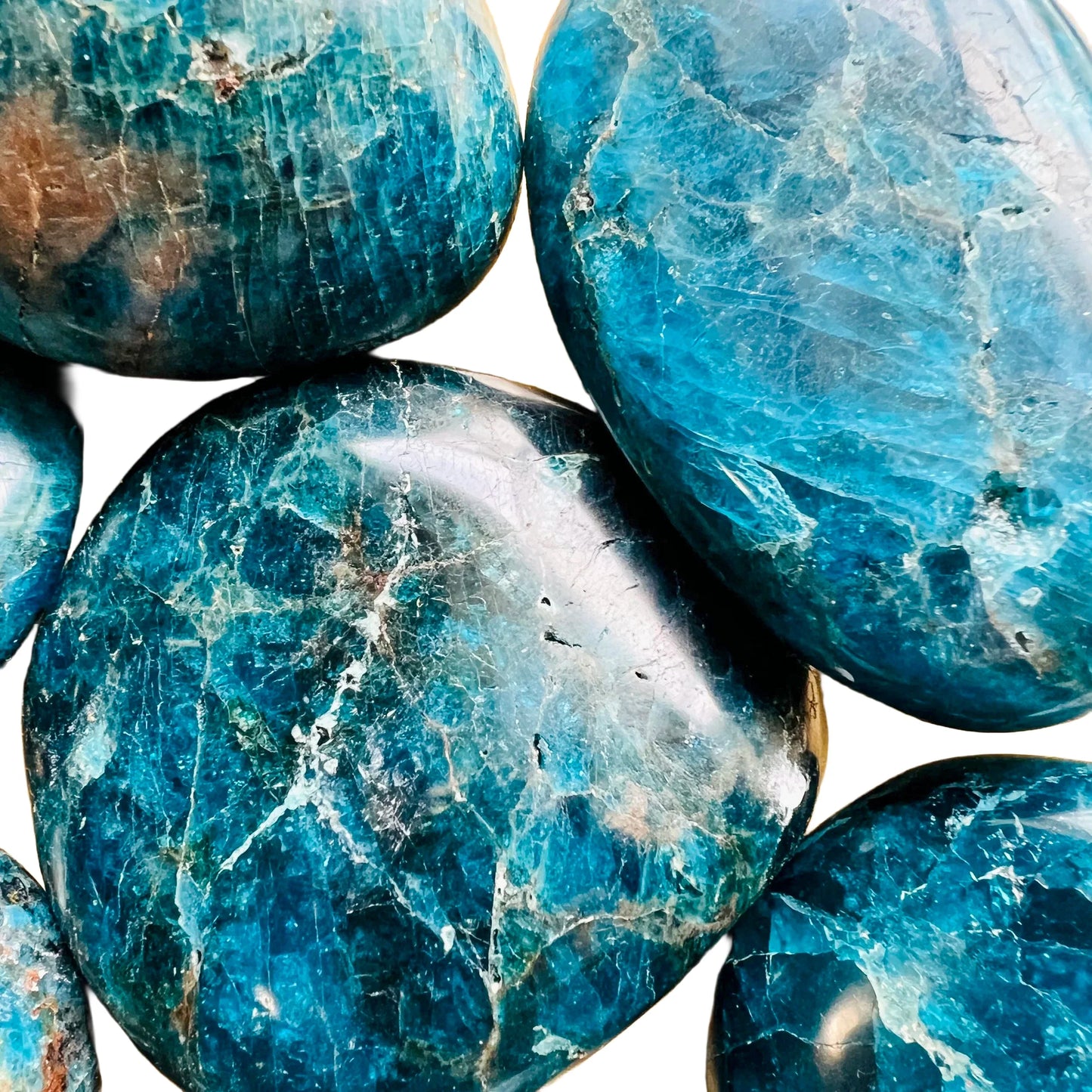 Scale reference of a Apatite palm stone held against natural backdrop, from Madagascar.