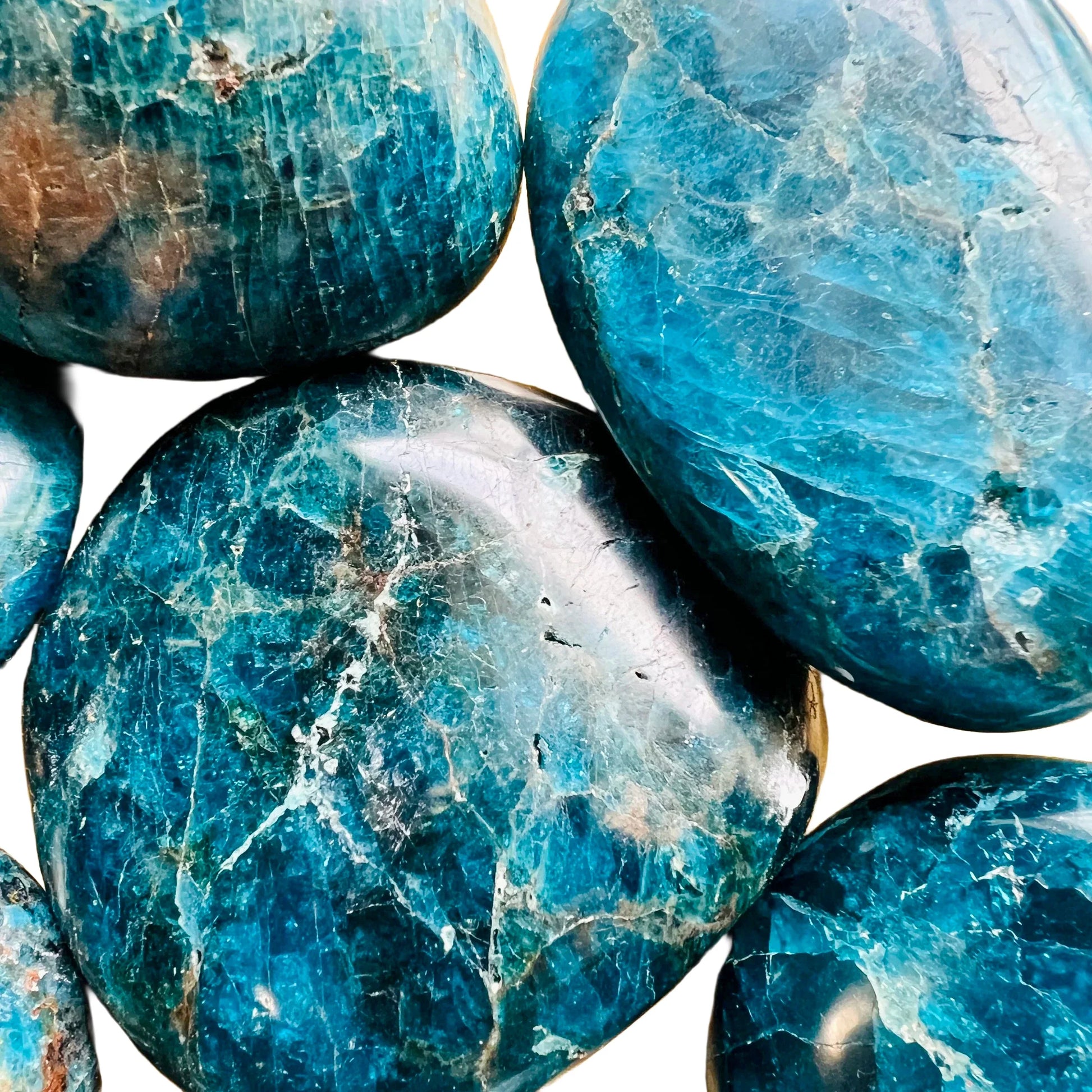 Scale reference of a Apatite palm stone held against natural backdrop, from Madagascar.
