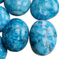 Overhead angle of Apatite palm stone, showing glassy finish.