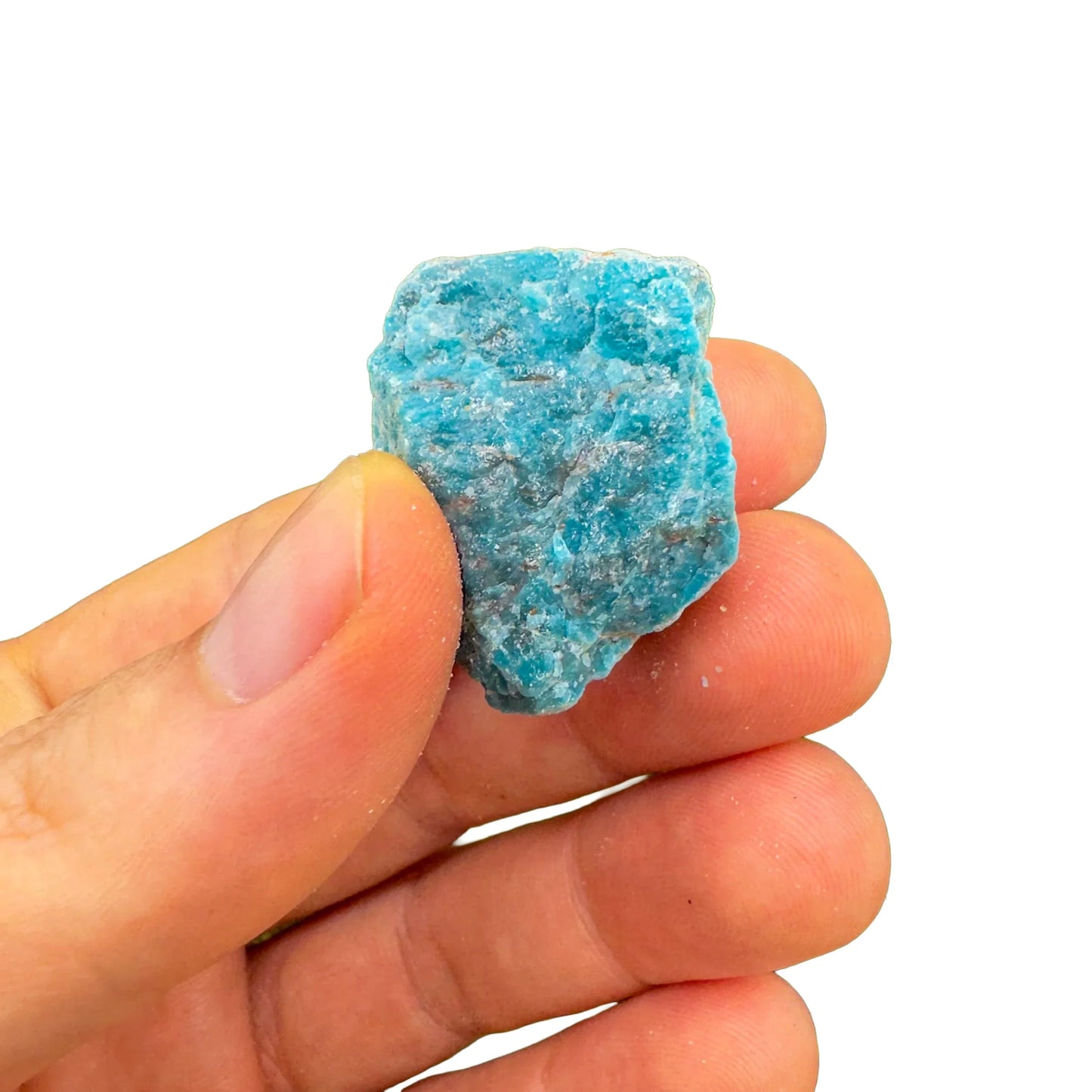 Side angle of blue Apatite raw stone, showing natural variation, sourced from Madagascar.