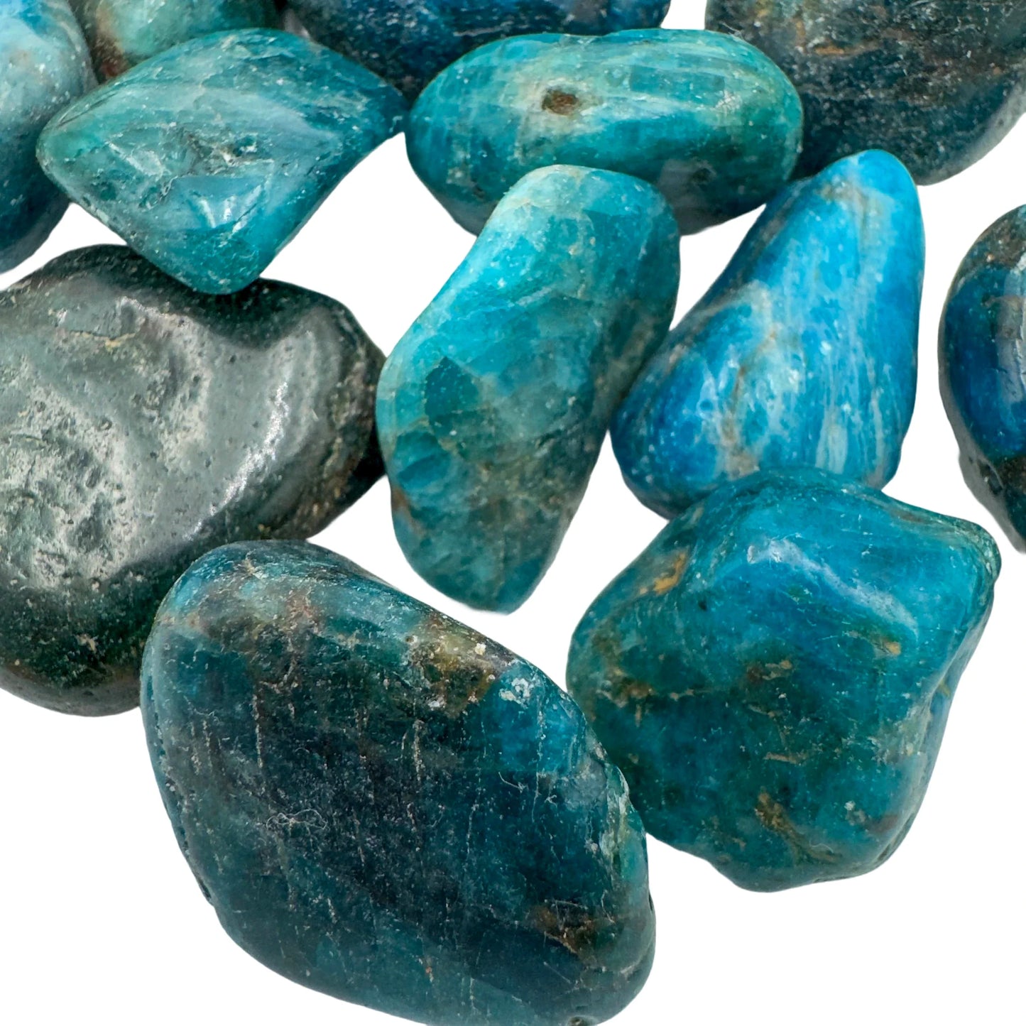 Hand-held view of a Apatite tumbled stone to support Focus, sourced from Anosy, Madagascar.