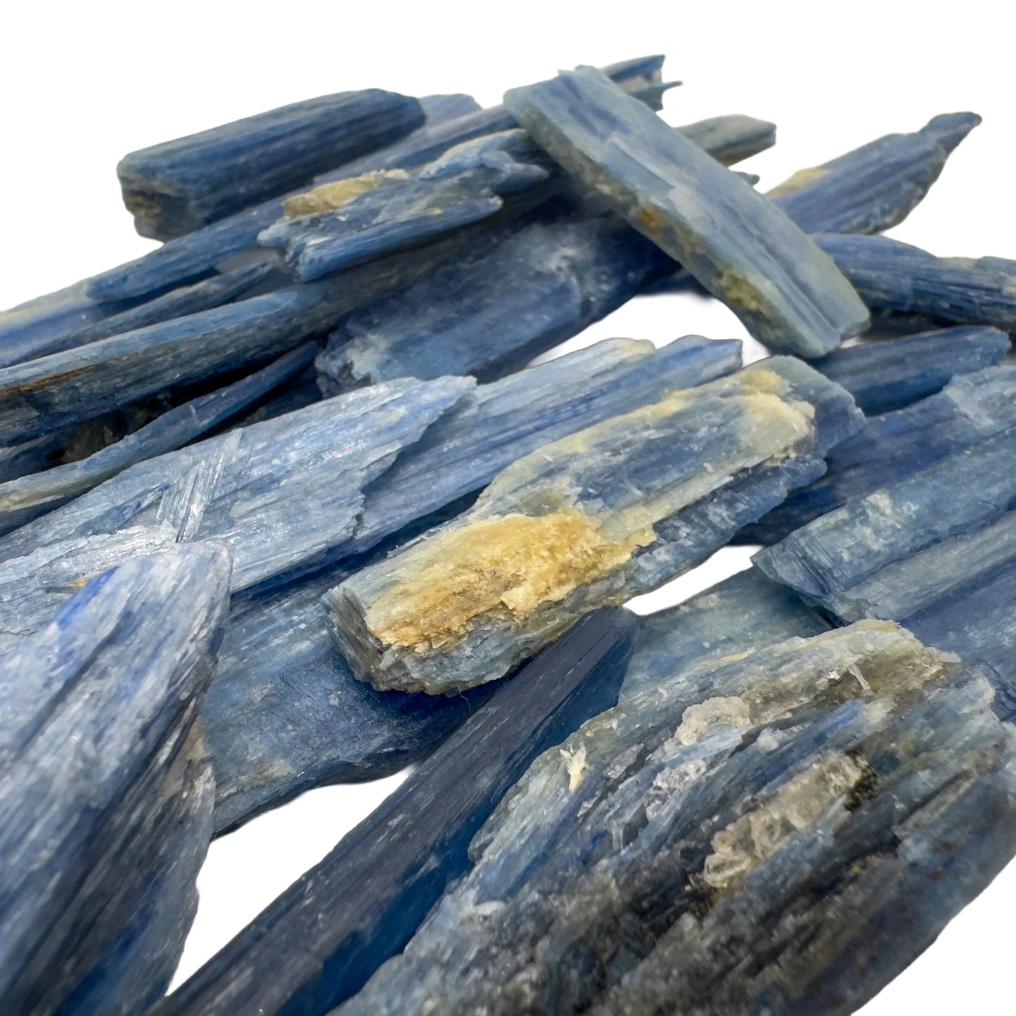 Grade aa blue kyanite raw held in hand for size reference