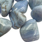Edge-on view of Blue Lace Agate tumbled stone, showing subtle veining.