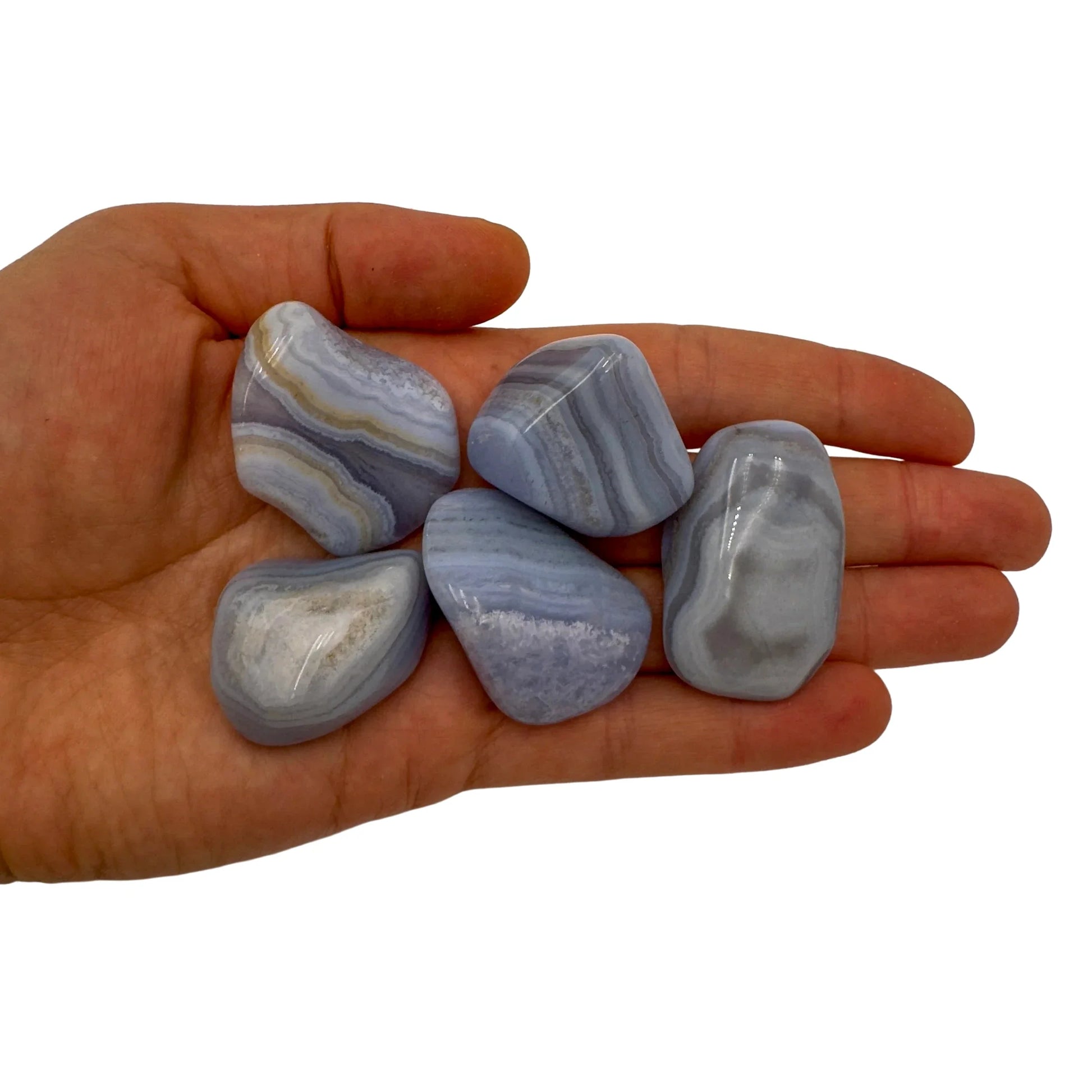 In-hand view of one Blue Lace Agate tumbled stone for scale, sourced from ǁKaras Region, Namibia.