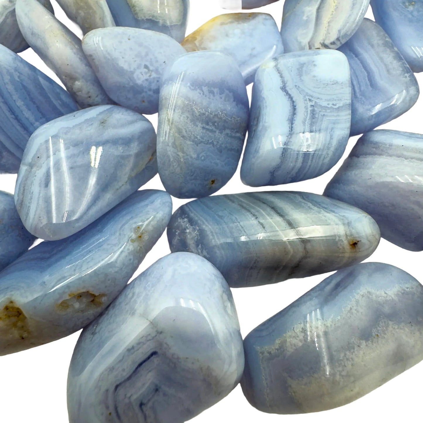 Sideways view of Blue Lace Agate tumbled stone, showing natural inclusions.