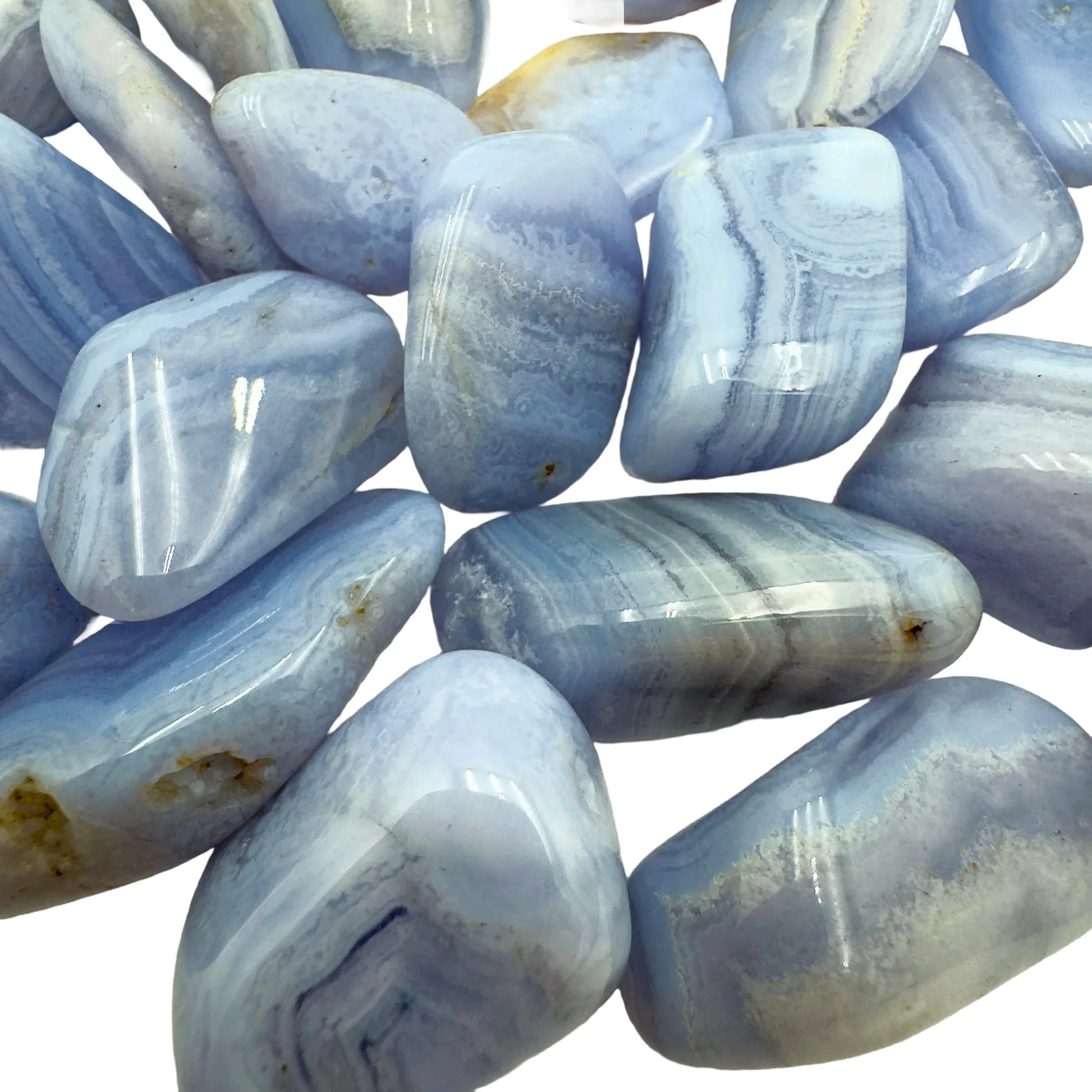 Sideways view of Blue Lace Agate tumbled stone, showing natural inclusions.