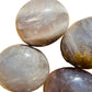 Detail shot of Grade A Blue Rose Quartz palm stone under natural light