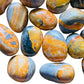 Hand-held view of one Bumblebee Jasper tumbled stone for scale, from Indonesia.