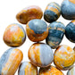Detail shot of Grade AA Bumblebee Jasper tumbled stone under natural light