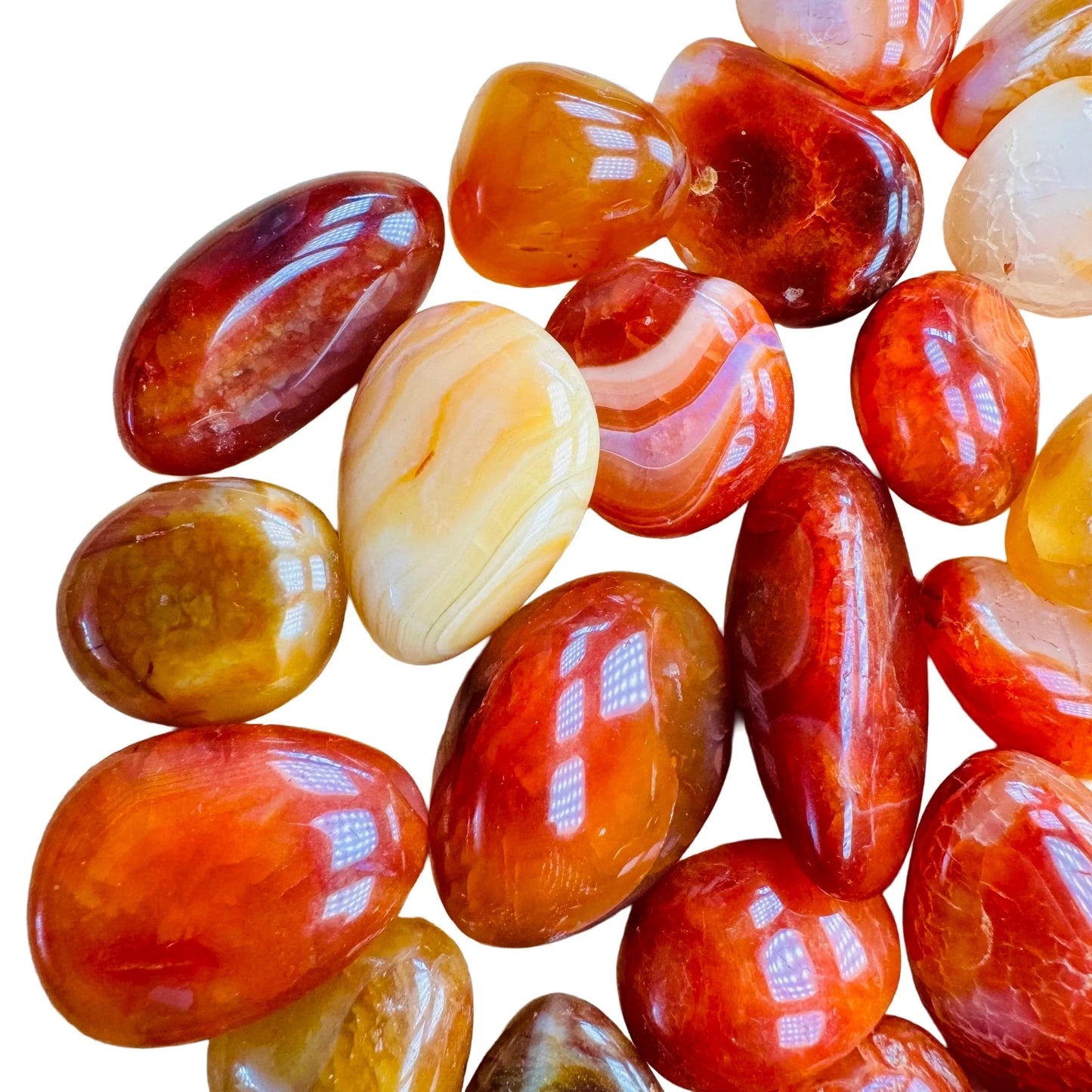 Close detail of Grade AA Carnelian tumbled stone, sourced from Madagascar, showing earthy tone.