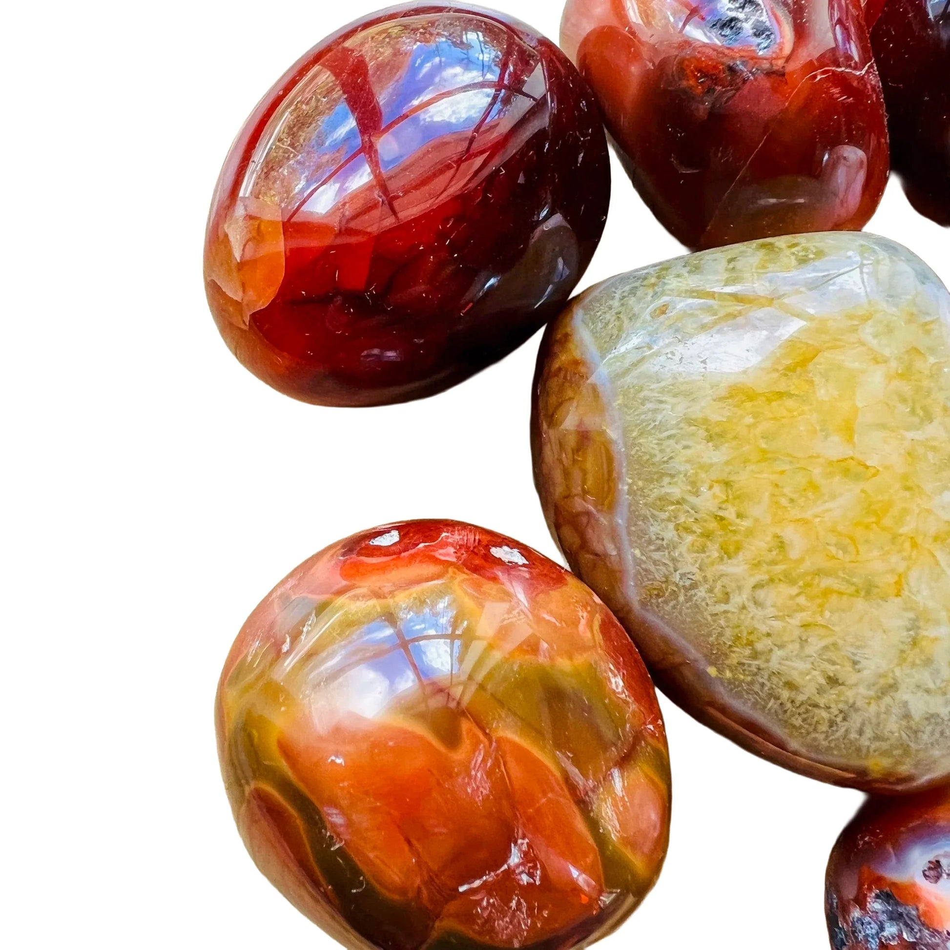 Top angle of Grade AA Carnelian palm stone, hand-selected from Boeny, Madagascar, showing natural inclusions.