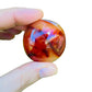 Back view of Grade AA Carnelian palm stone showing natural surface