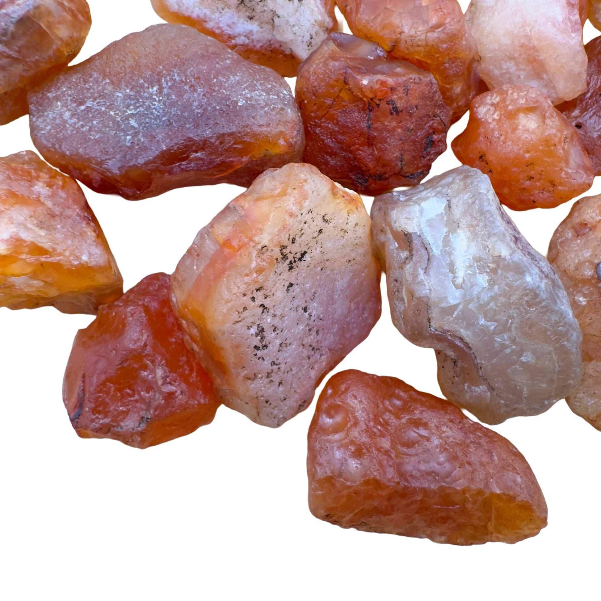 Profile view of orange Carnelian raw stone, showing honest grain, linked to Energy and Confidence.