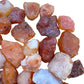 Palm-scale view of a single Carnelian raw stone hand-selected from Nsipe, Malawi.