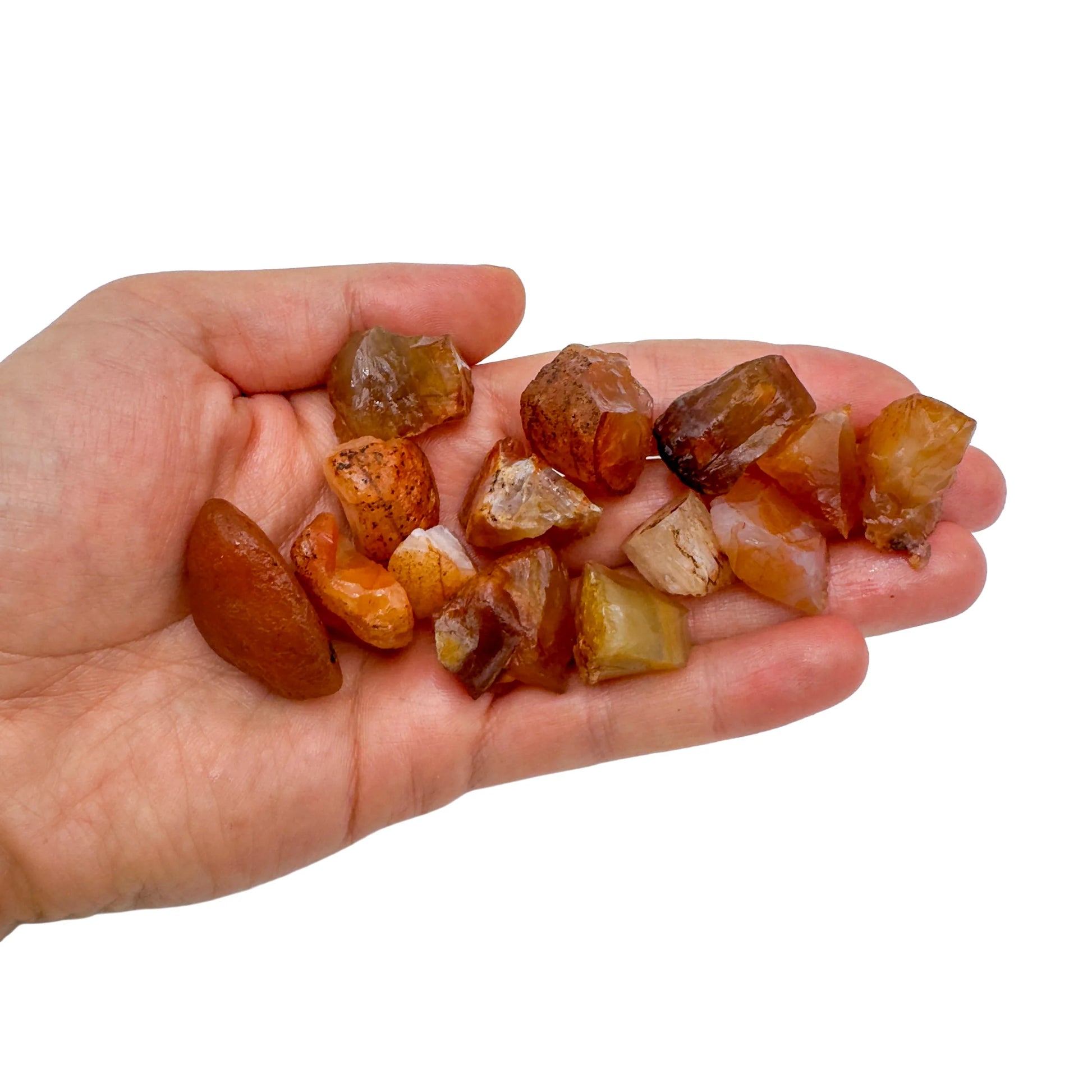 Held in hand, a Carnelian raw stone, from Brazil.