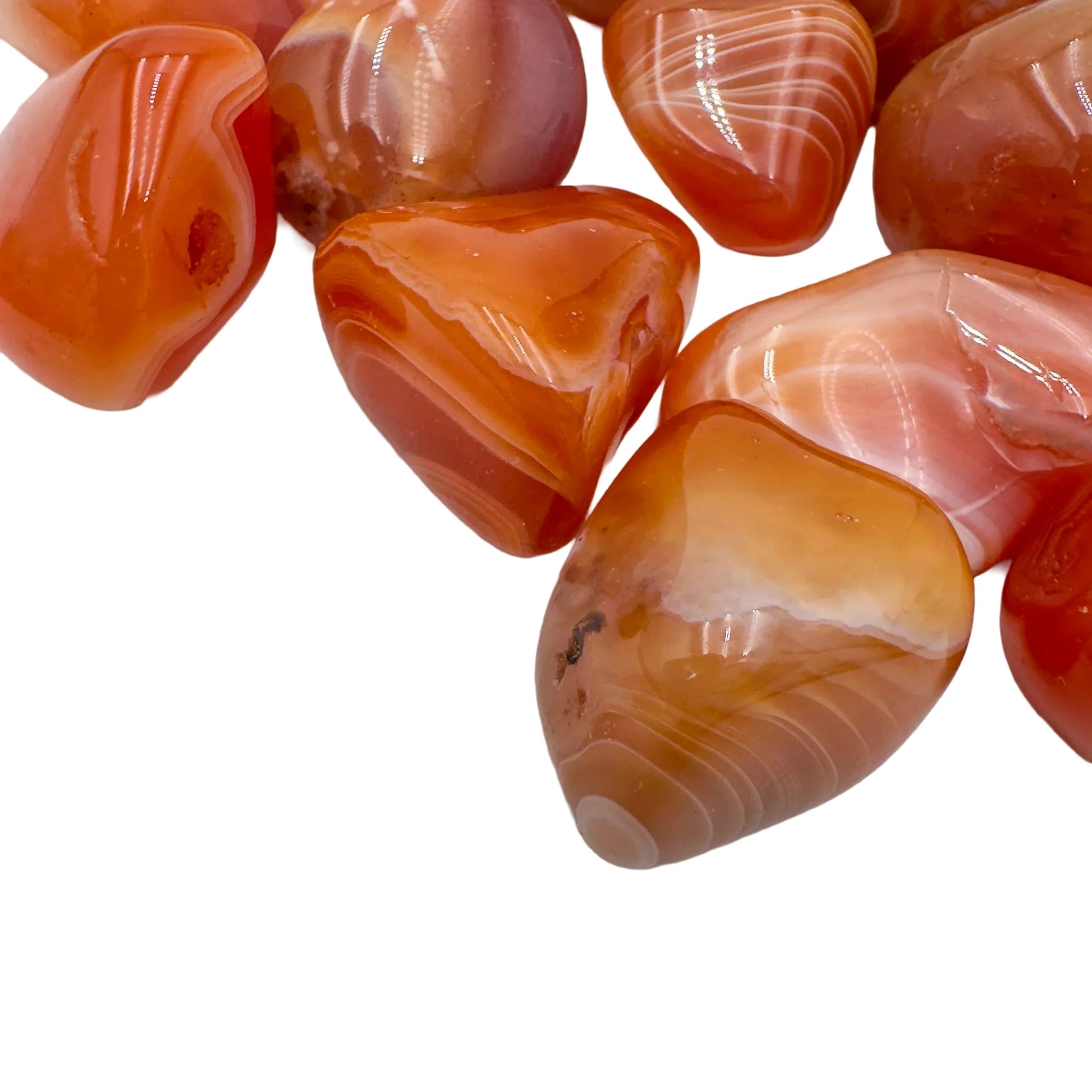 Overhead view of Grade AA Carnelian tumbled stone, from Botswana, linked to Energy and Confidence.