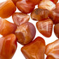 Underside detail of orange Carnelian tumbled stone, from Francistown, Botswana, for Energy.