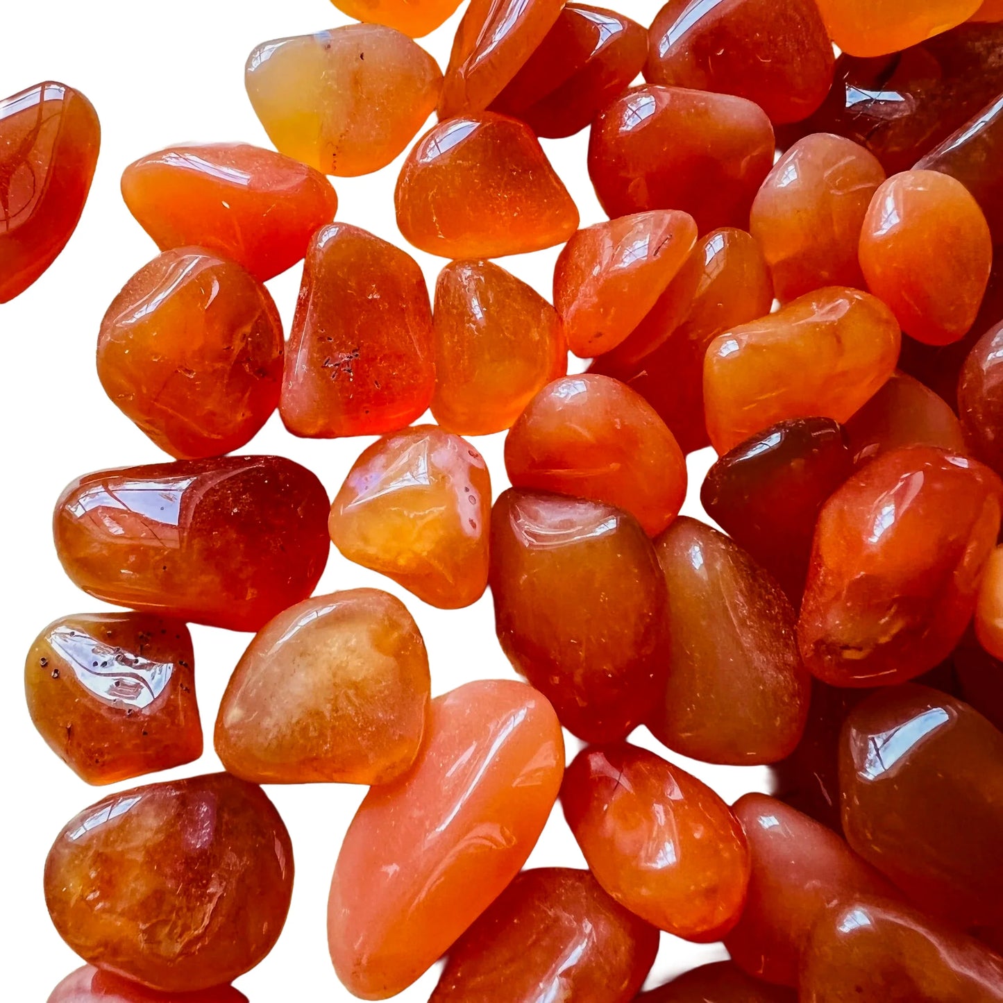 Sideways view of Carnelian tumbled stone, kept near for Energy and Confidence, showing color depth.