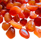 Overhead angle of Grade AA Carnelian tumbled stone, showing characteristic color, associated with Energy.