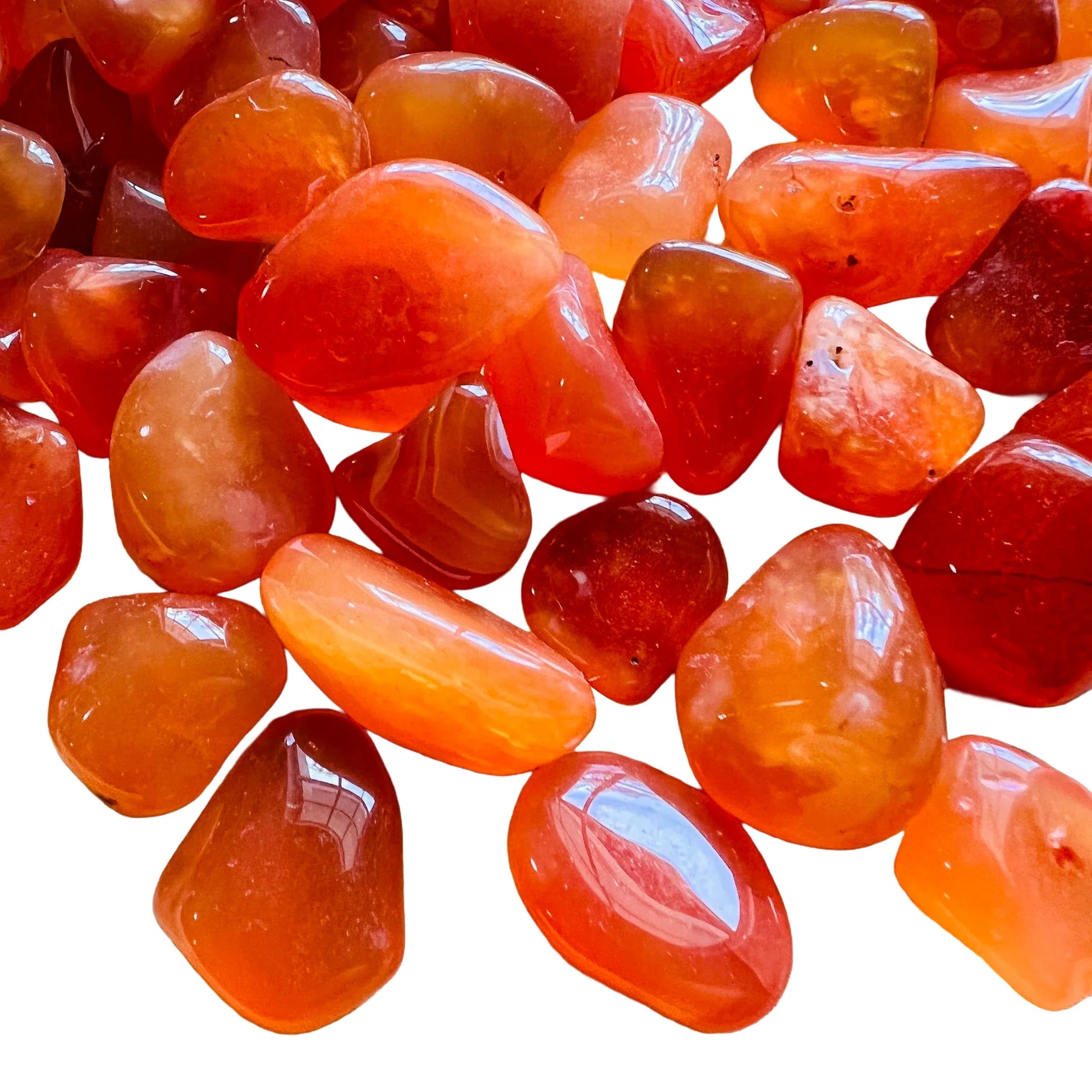 Overhead angle of Grade AA Carnelian tumbled stone, showing characteristic color, associated with Energy.
