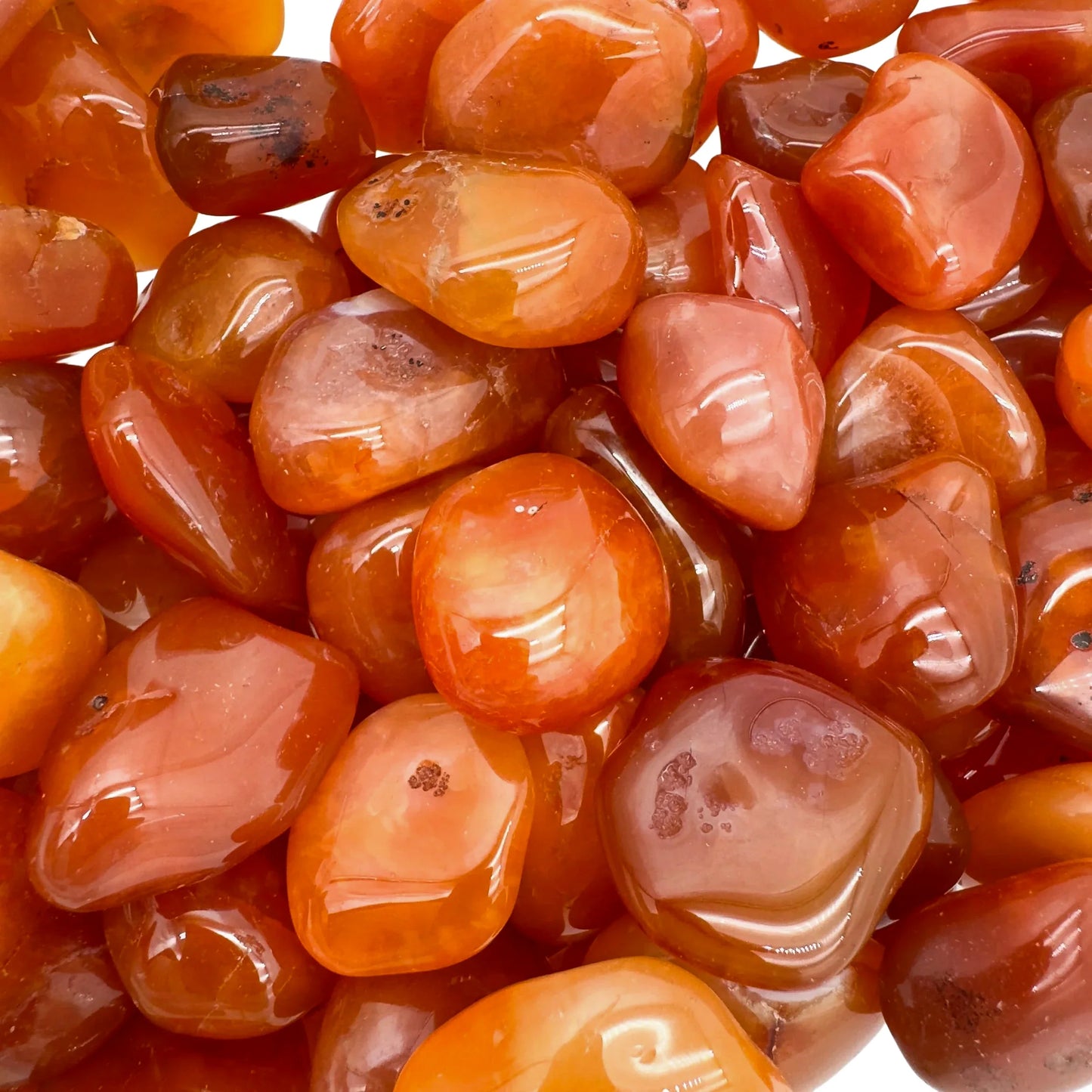 Top-side view of orange Carnelian tumbled stone, often kept for Energy and Confidence.