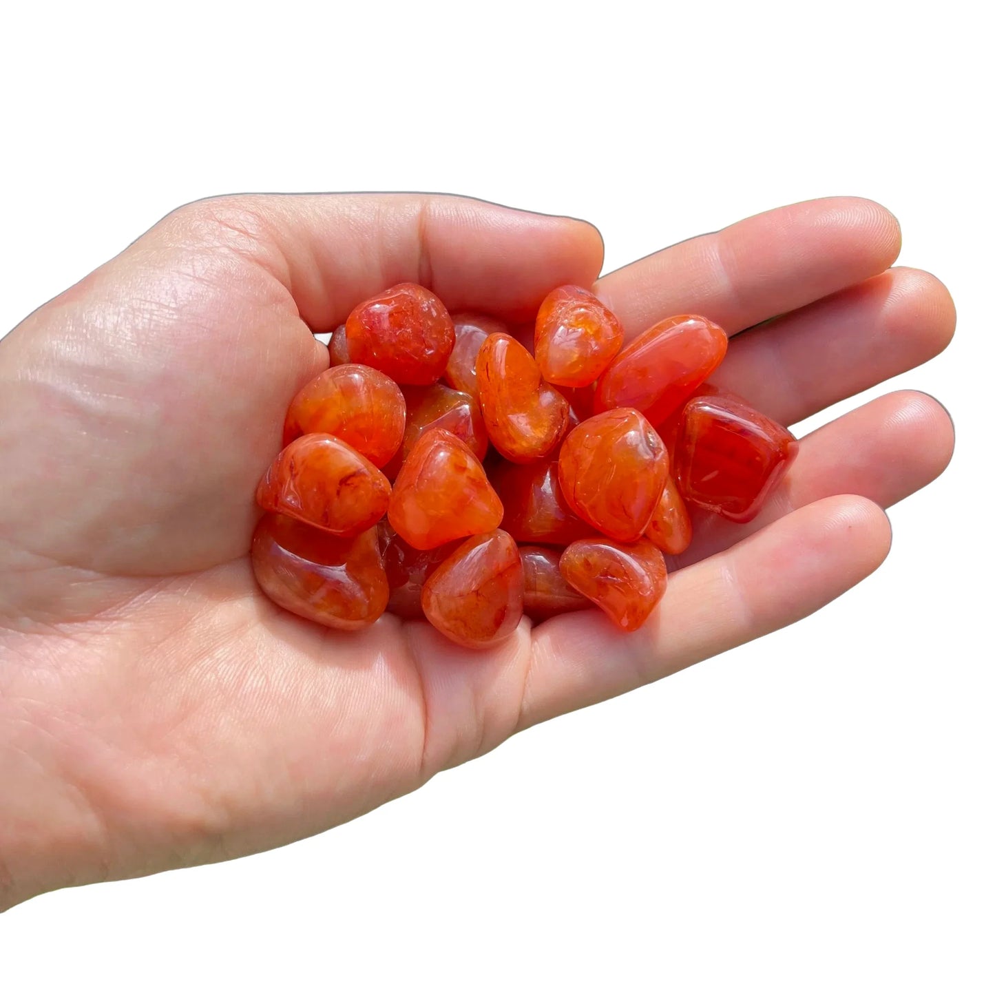 Detail shot of Grade AA Carnelian tumbled stone under natural light
