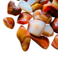 Side-on view of Carnelian tumbled stone, showing earthy tone.