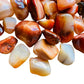 Overhead view of Carnelian tumbled stone, often worked with for Energy and Confidence.