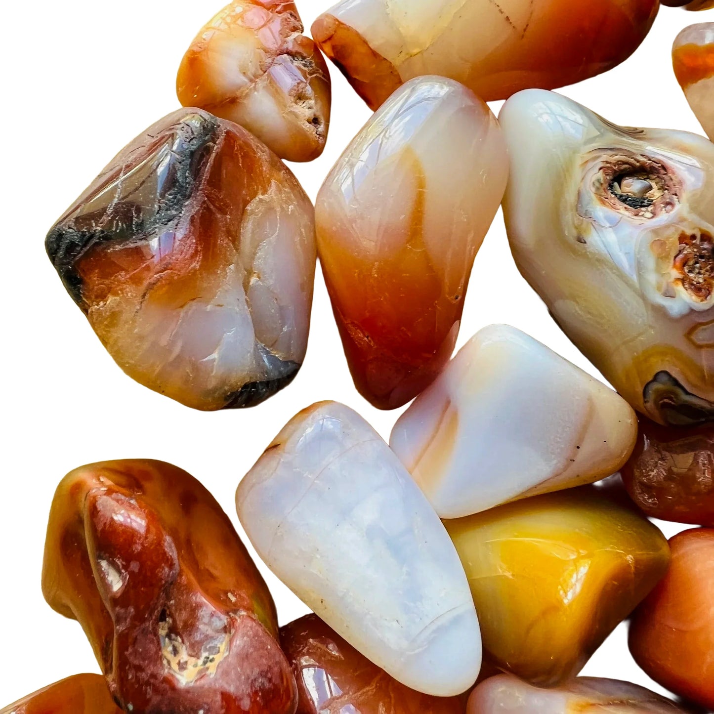 Daylight view of one Carnelian tumbled stone for scale, hand-selected from Boeny, Madagascar.