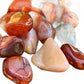Companion image of Carnelian tumbled stone, from Boeny, Madagascar, with natural details visible.