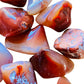 Close-up of Carnelian tumbled stone, Madagascar-sourced, showing earthy tone.
