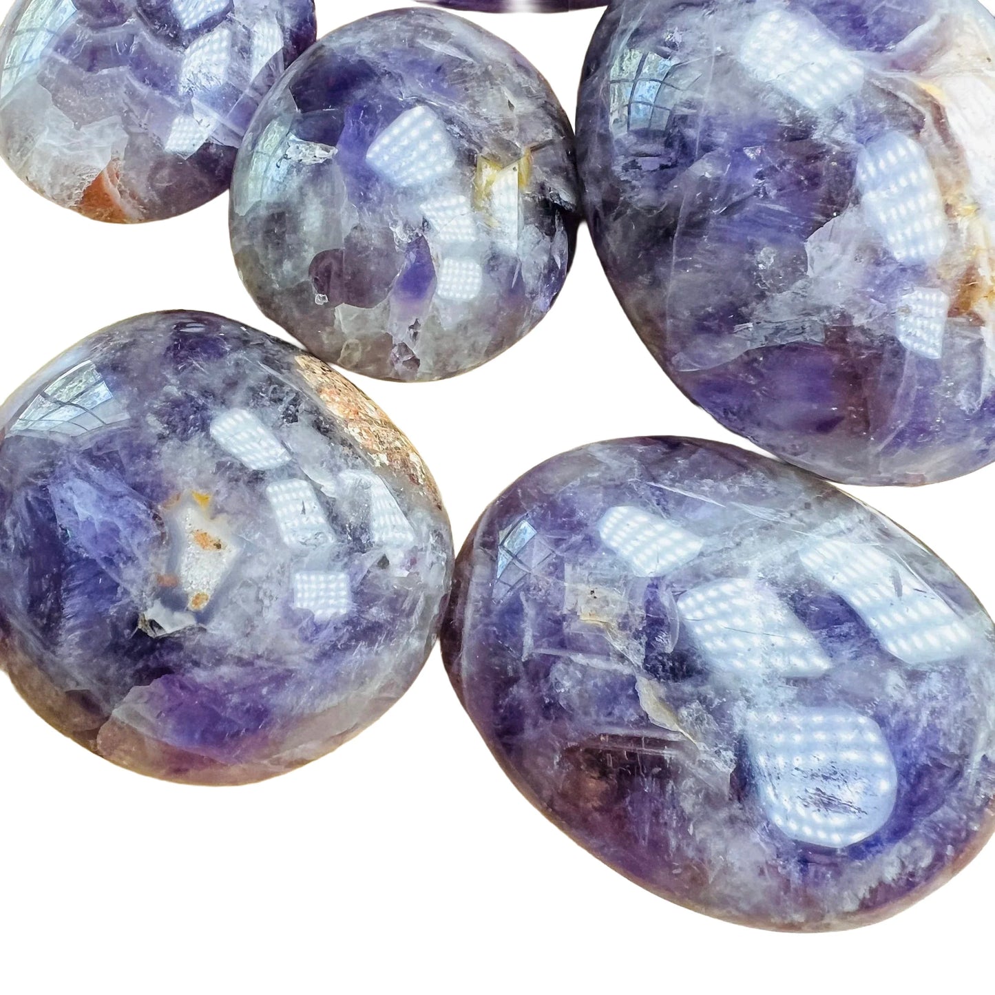 Side profile of Chevron Amethyst palm stone, showing earthy tone, associated with Intuition.