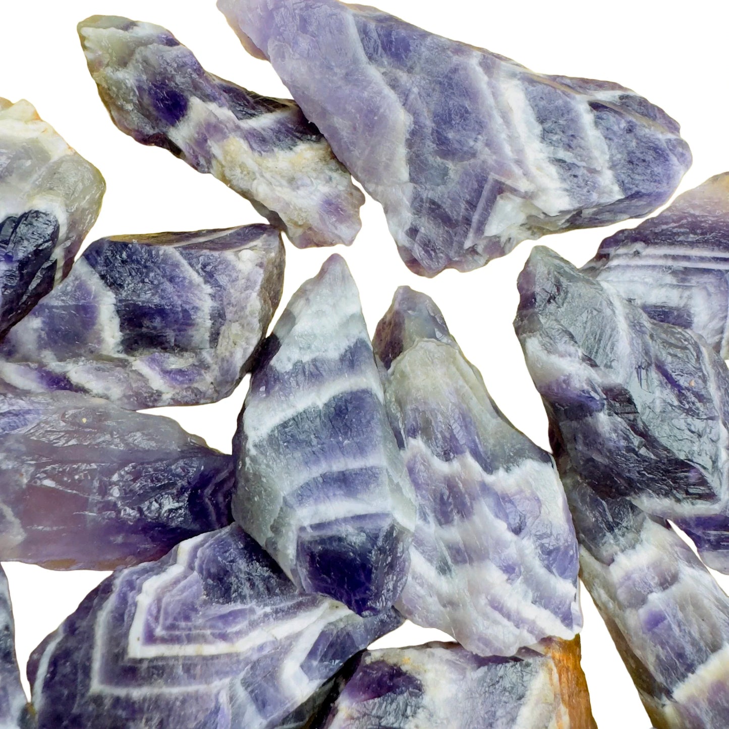 Held in hand, a single Chevron Amethyst raw stone sourced from Zambia.